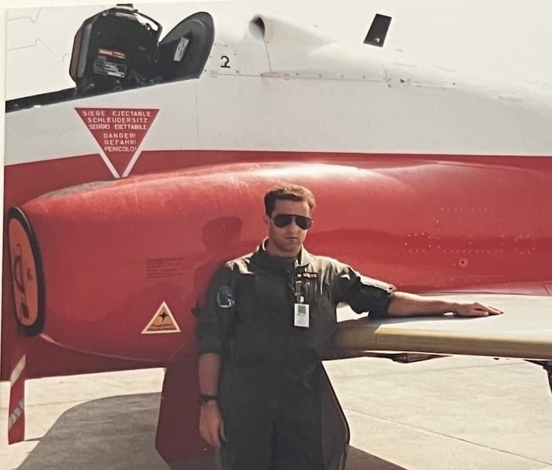 Captain Marcel Suess standing beside a Swiss Air Force fighter jet during active service